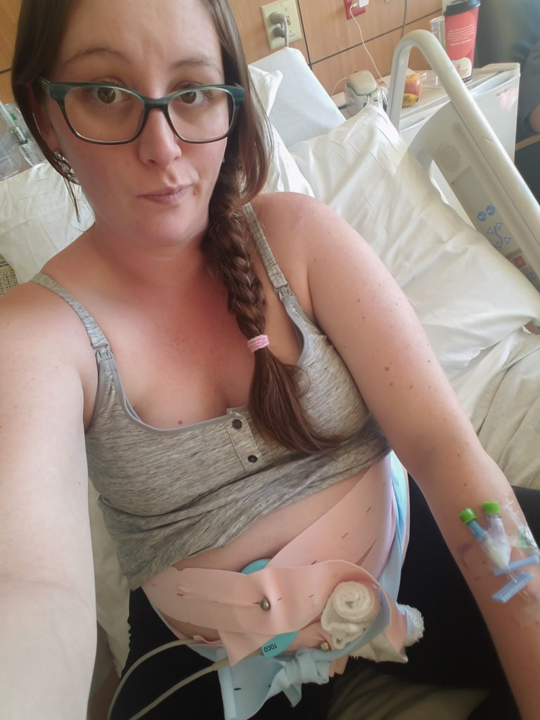 A photo of the pregnant author while her and her baby are attached to the heart and contraction monitors at University of Colorado Anschutz in Aurora Colorado
