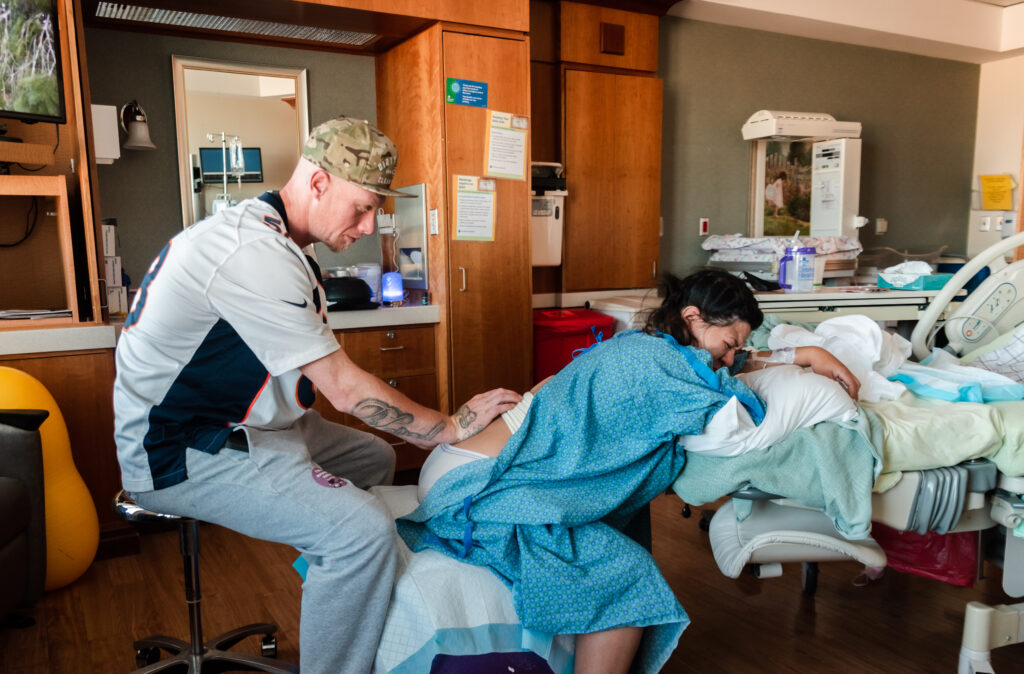 Father providing hands on support to laboring wife at Avista hospital in Colorado.