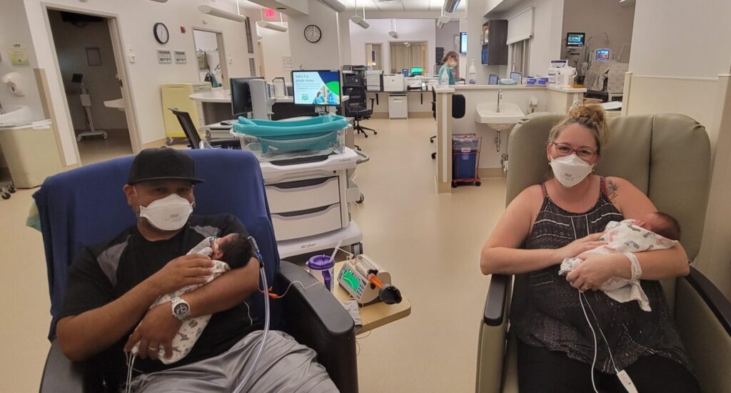 Mom and dad each holding a twin in the NICU at Avista Hospital Colorado