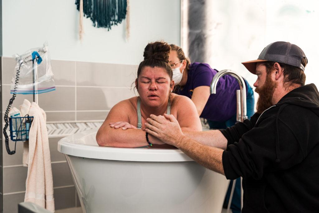 photo of laboring in the bathtub by longmont birth photographer