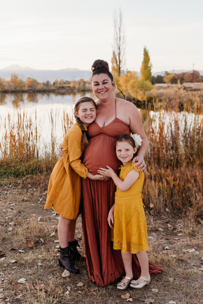 Family maternity photo mountain background orange and yellow dresses