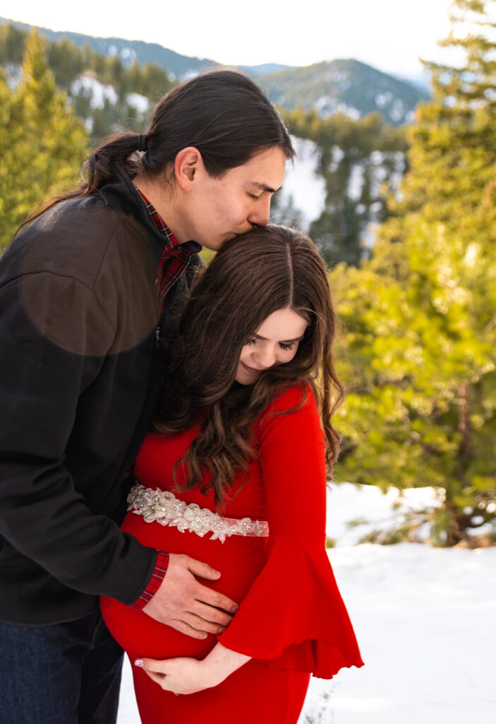 Red Maternity dress in snow - Longmont Colorado maternity photographer