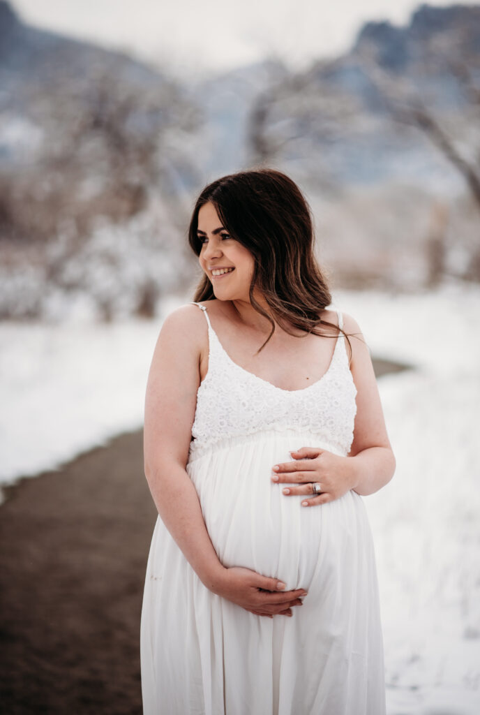 white maternity dress in snow Longmont Colorado maternity photography