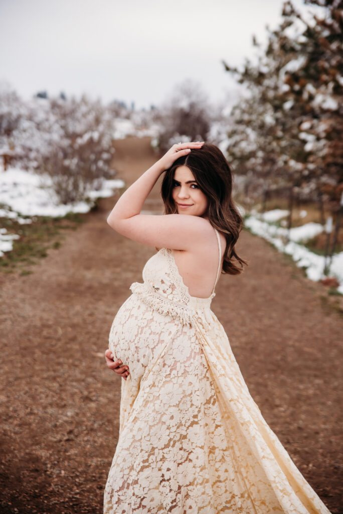 white maternity dress in snowy mountains Longmont Colorado maternity photography