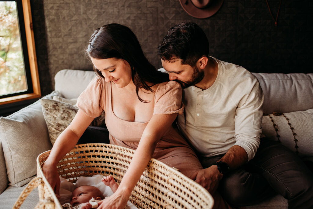 Sweet moment between new parents in their home newborn photography session