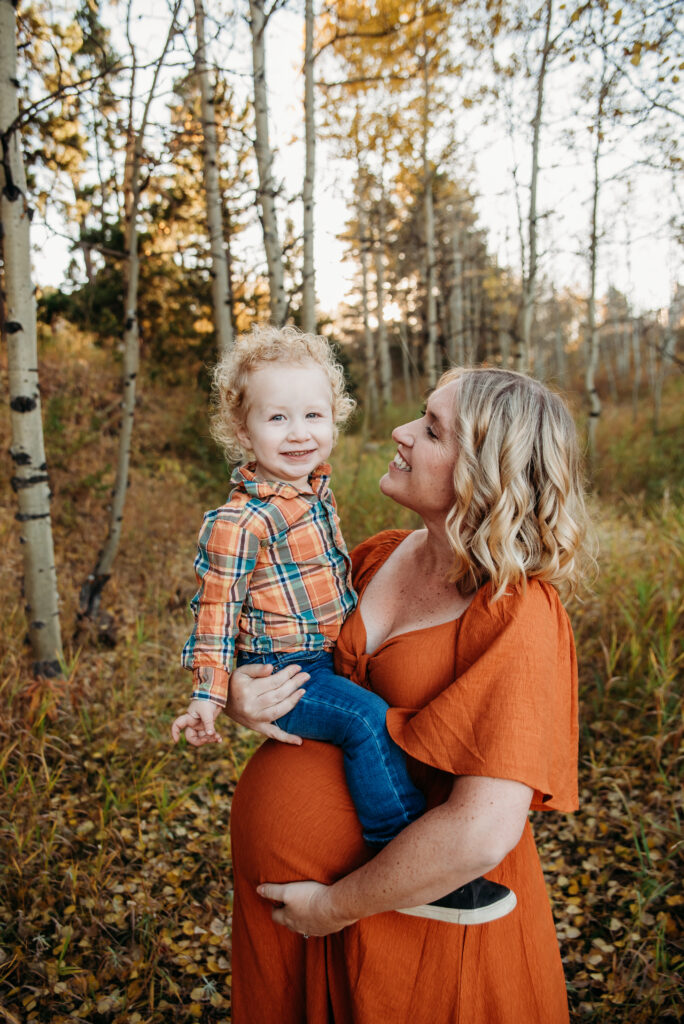 Orange dress family maternity photo with mom and son with Aspen trees in Nederland Colorado