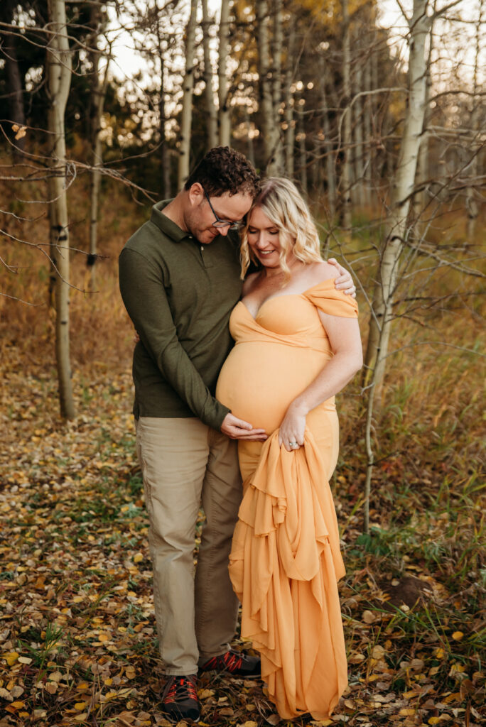 mom and dad embracing belly in maternity photo in Nederland Colorado