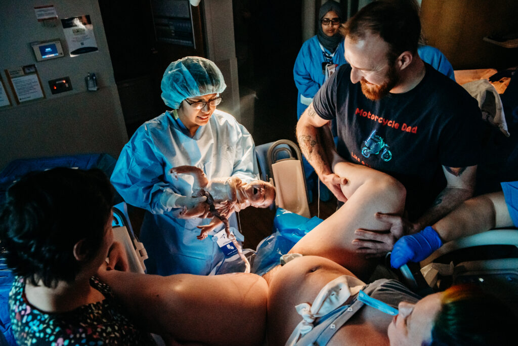 Dr Nalla with Centura Health Physician Group in Longmont CO catching a baby being born. Part of a birth story.