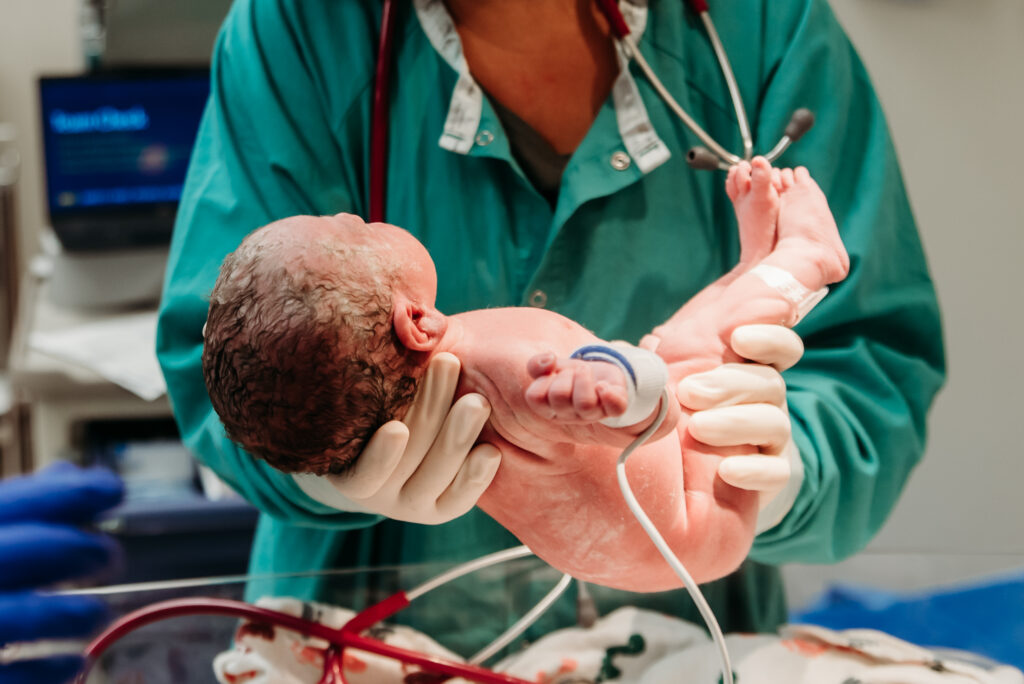 Nurse holding new baby at the warmer Avista hospital Colorado