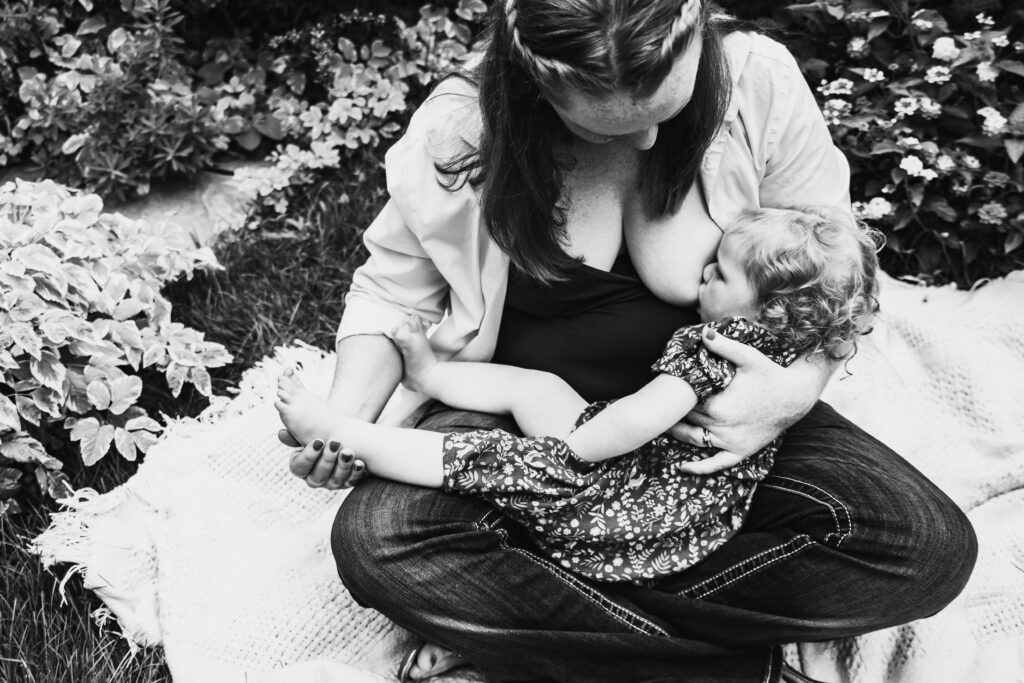 Garden breastfeeding photo black and white mom and daughter