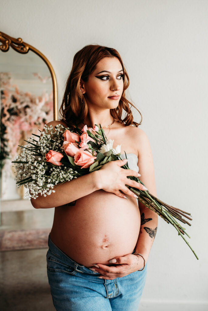 lifestyle studio maternity photography Longmont Colorado Sugarhill studio flowers and pregnant belly