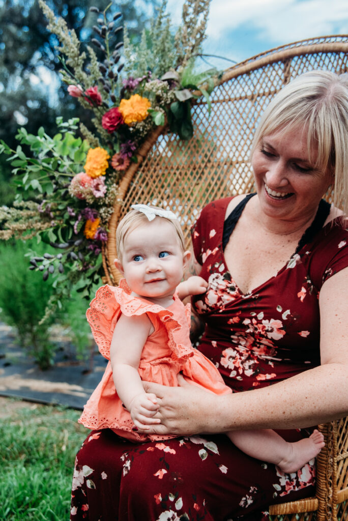 Wozani Farm mom and daughter photo floral arrangement peacock chair