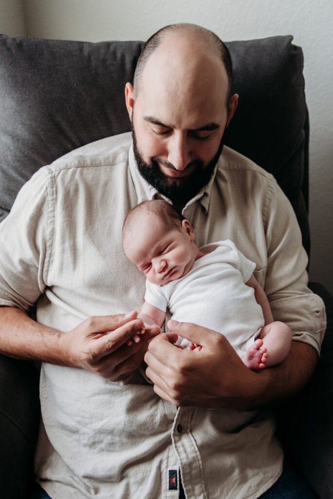 dad and baby in home longmont newborn photographer