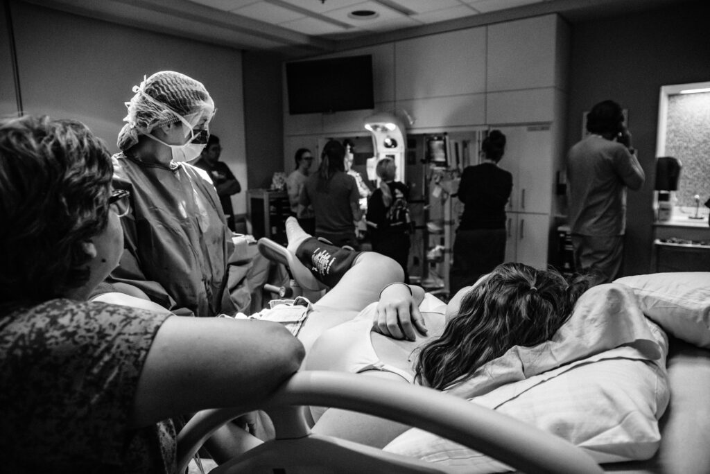 Birth photo of mom's view of the birth team working to resuscitate baby at Children's Hospital Colorado. 