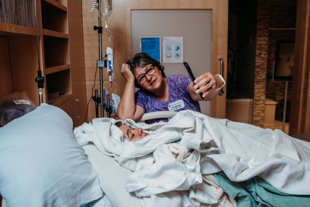 Photo of a grandma showing photos of her daughter's baby in NICU