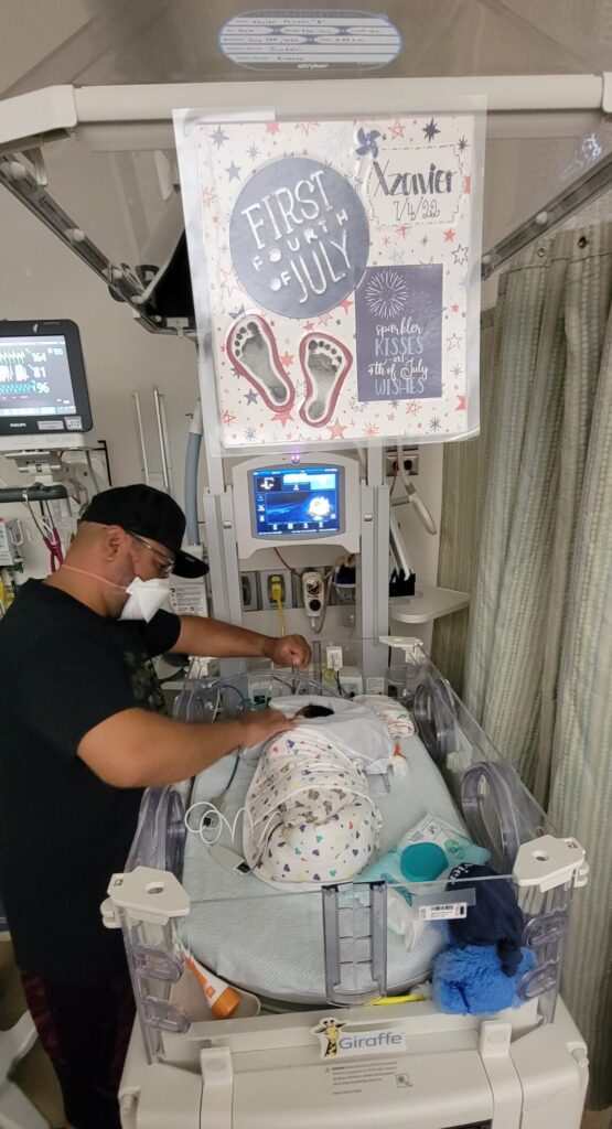 Avista Hospital Colorado NICU decorated our twins' isolettes for the 4th of July. Dad doing NICU cares.