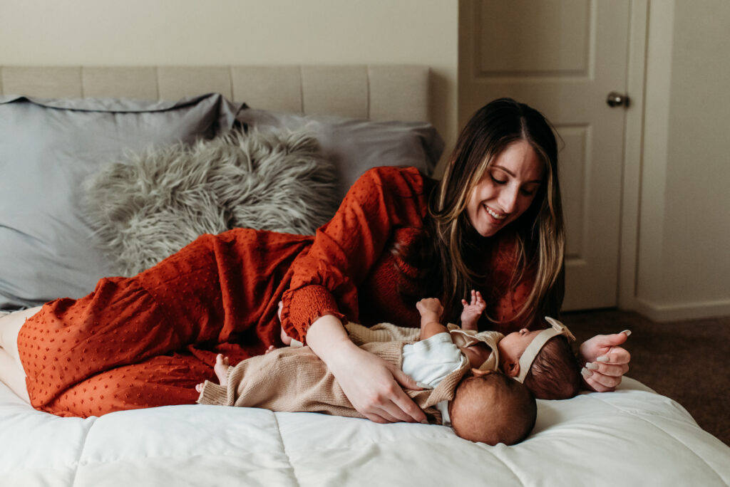 mom with boy girl newborn twins