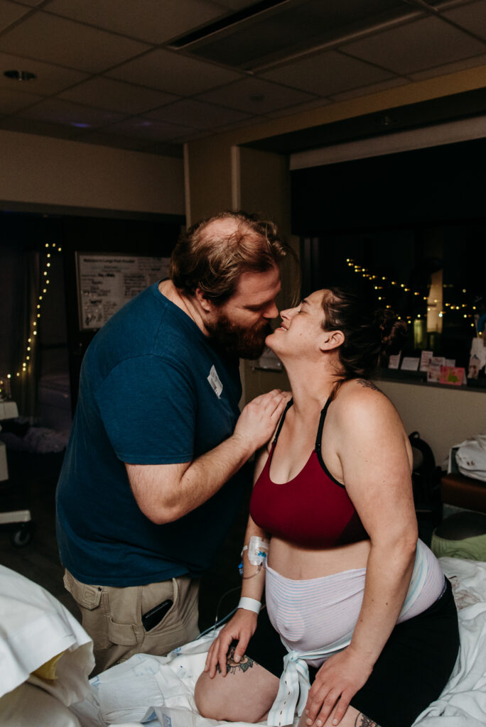 Mom and dad sharing a quick kiss during labor