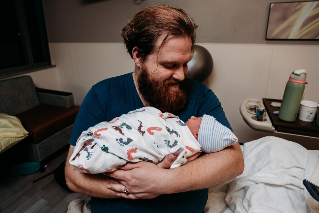 dad holding his son for the first time