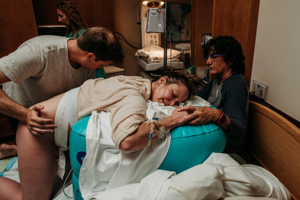 dad and doula supporting laboring mom
