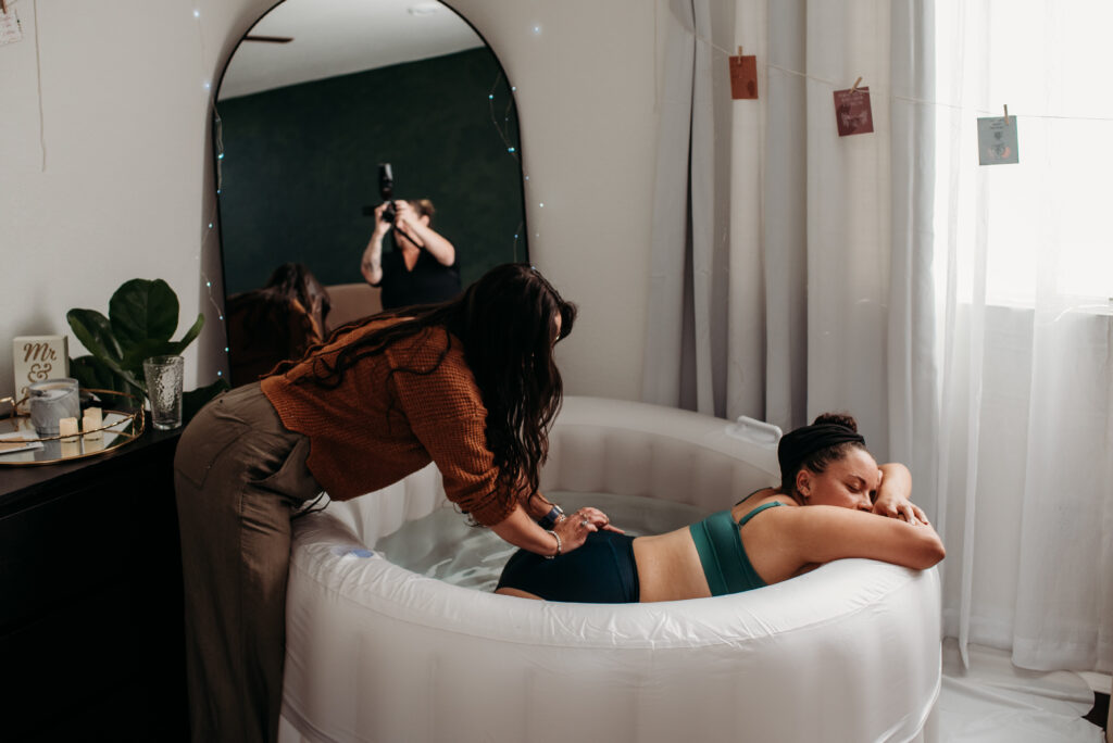 birth photographer working with laboring mom and doula sacral pressure labor
